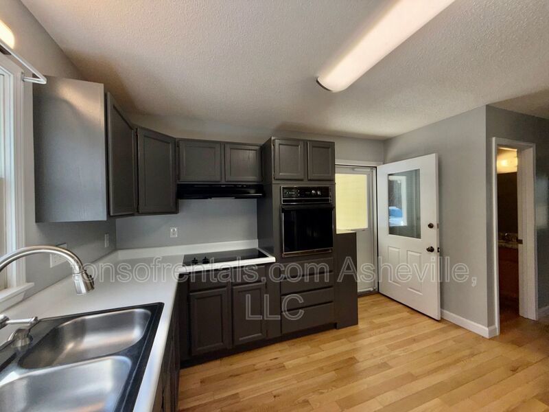 This beautiful freshly painted single-family home in Pisgah Forest, NC offers 3 bedrooms, 2.5 bathrooms, and multiple living spaces including a bonus room and a gas fireplace. property image