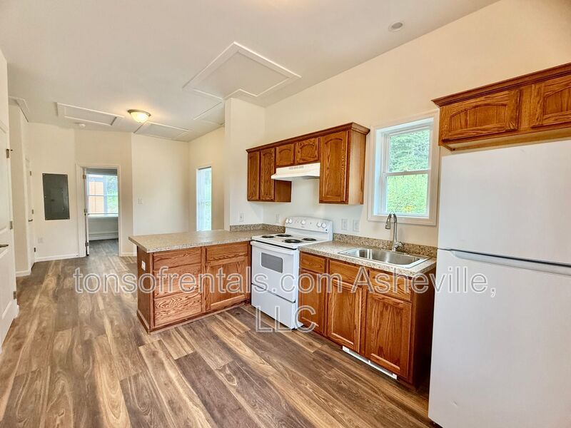 Freshly built upstairs duplex unit in Brevard, NC, offering a bright one-bedroom, one-bath layout with an open floor plan and vinyl flooring throughout. property image