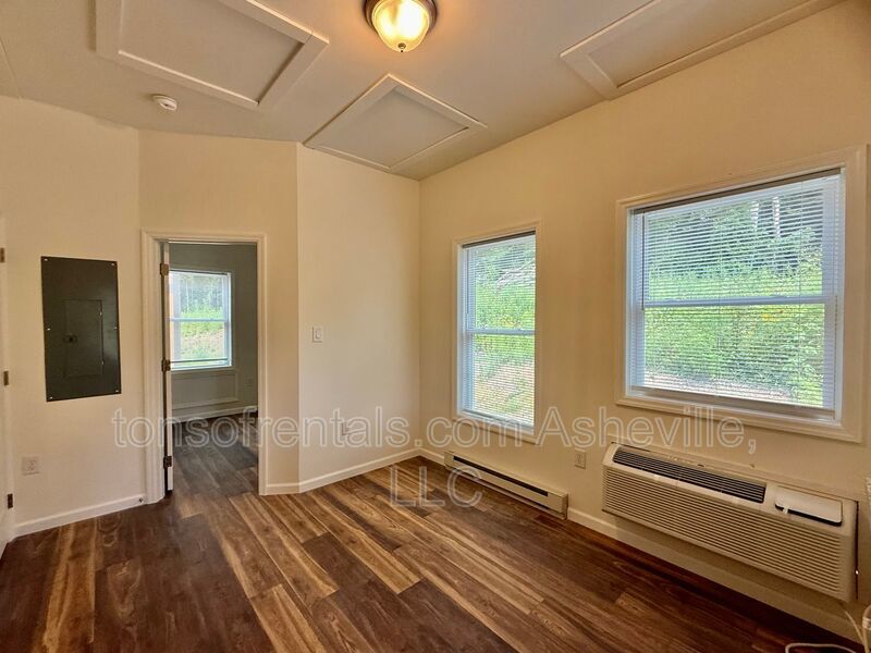 Freshly built upstairs duplex unit in Brevard, NC, offering a bright one-bedroom, one-bath layout with an open floor plan and vinyl flooring throughout. property image