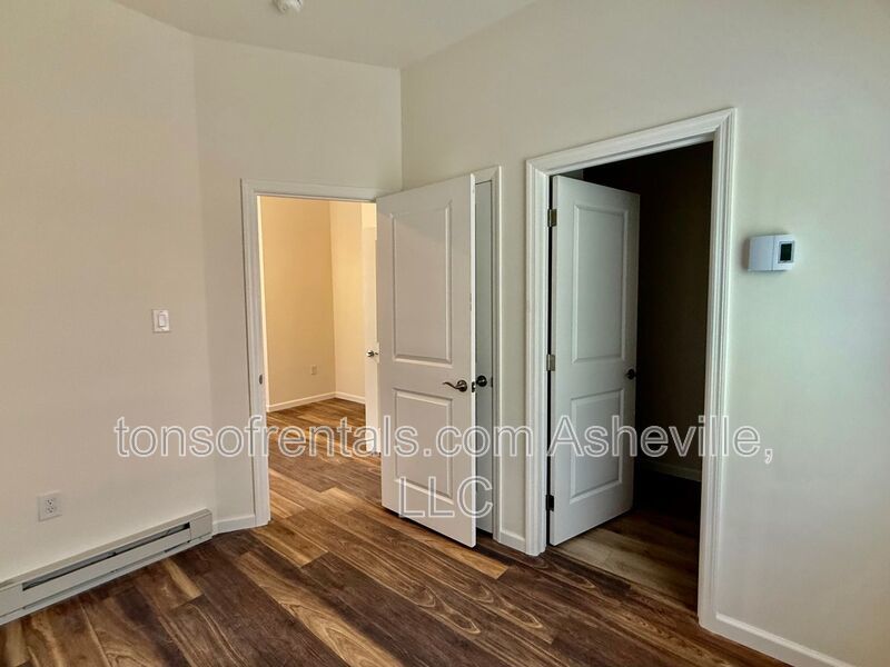 Freshly built upstairs duplex unit in Brevard, NC, offering a bright one-bedroom, one-bath layout with an open floor plan and vinyl flooring throughout. property image