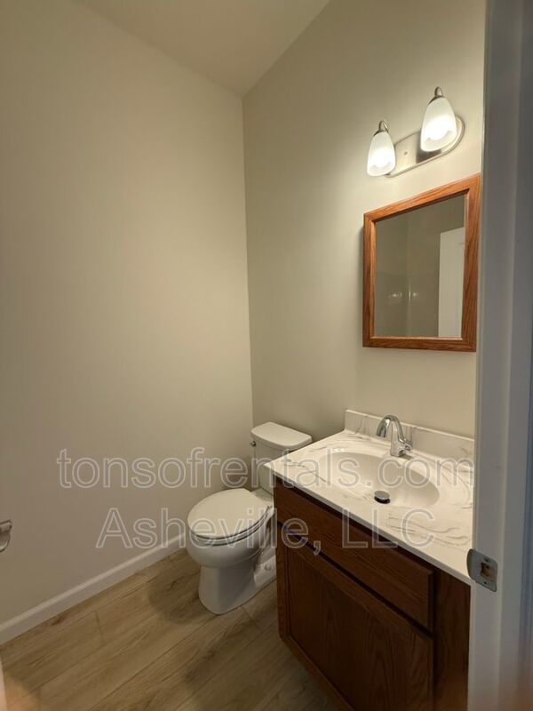 Freshly built upstairs duplex unit in Brevard, NC, offering a bright one-bedroom, one-bath layout with an open floor plan and vinyl flooring throughout. property image